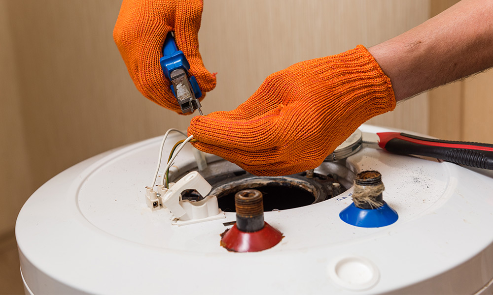 plumber hands close up with gloves repairing water heater installation Dallas TX