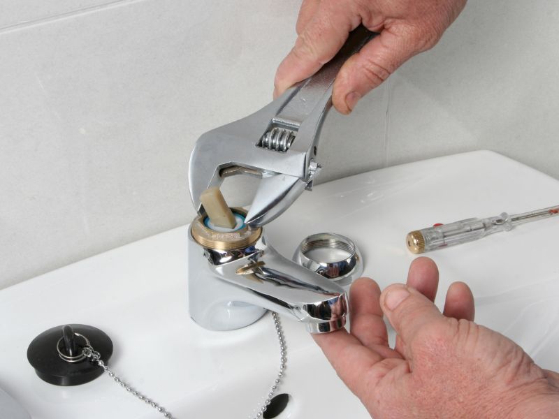 plumber installing new faucet at bathroom red oak tx